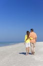 Couple Walking on An Empty Beach Royalty Free Stock Photo