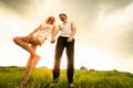 Couple walking through the field and holding hands Royalty Free Stock Photo