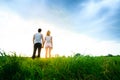 Couple walking through the field and holding hands Royalty Free Stock Photo