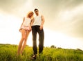 Couple walking through the field and holding hands Royalty Free Stock Photo