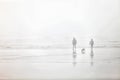 A couple walking on a foggy beach.