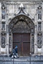 A couple walking in front the main entrance of the Saint-Nicolas-des-champs church in Paris