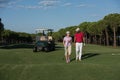 Couple walking on golf course Royalty Free Stock Photo