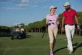 Couple walking on golf course Royalty Free Stock Photo