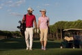 Couple walking on golf course Royalty Free Stock Photo