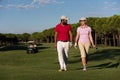 Couple walking on golf course Royalty Free Stock Photo