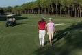 Couple walking on golf course Royalty Free Stock Photo