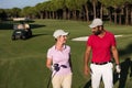 Couple walking on golf course Royalty Free Stock Photo