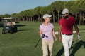 Couple walking on golf course Royalty Free Stock Photo