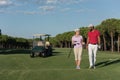 Couple walking on golf course Royalty Free Stock Photo