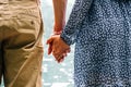 Couple walking. Happy young romantic people holding hands. Love couple man and woman together in summer park. Young Royalty Free Stock Photo