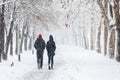 Couple walking during heavy snowstorm