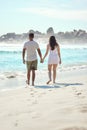 Couple, walking and holding hands with love on beach for summer vacation, travel and tour in California for anniversary Royalty Free Stock Photo