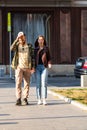 Couple walking holding their hands on the sidewalk of Victoriei Way Calea Victoriei in Bucharest, Romania, 2019 Royalty Free Stock Photo