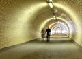 Couple walking in a long tunnel