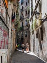 Couple Walking in a Narrow Barcelona Street with Antique Lamppost in the Gothic Neighborhood of Barcelona, Spain Royalty Free Stock Photo