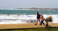 A couple walking near the sea in storm Royalty Free Stock Photo
