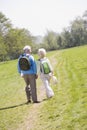 Couple walking on path in park holding hands Royalty Free Stock Photo