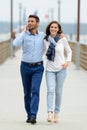 couple walking on pier on seaside