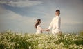 Couple walking in poppy field holding hands smiling, love and romance Royalty Free Stock Photo