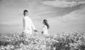 Couple walking in poppy field holding hands smiling, love and romance Royalty Free Stock Photo