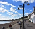 Couple walking on promenade in sea town .