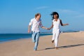 Couple walking and running on beach Royalty Free Stock Photo