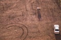 Couple walking on the sand near a car. view from above of a couple of tourists. aerial view. concept with copy space