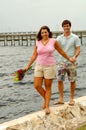 Couple walking on sea wall Royalty Free Stock Photo