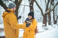 Couple walking by snowed city park talking socializing. romantic date in winter time Royalty Free Stock Photo