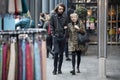 The couple are walking in the Spitalfield market area against a