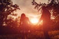 Couple walking in spring forest. Young man and girl holding hands at sunset. Royalty Free Stock Photo