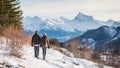 Couple walking in winter mountain. Rear view of man and woman hiking in winter mountains