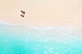 A couple walks along the Beach of Mauritius in the Indian ocean. Top view of the beach with turquoise water on the tropical island Royalty Free Stock Photo