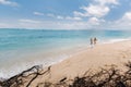 A couple walks along the Beach of Mauritius in the Indian ocean. Top view of the beach with turquoise water on the Royalty Free Stock Photo