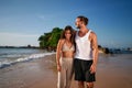 Couple walks on beach, adult duo sans kids enjoys seaside stroll. Childless pair on vacation smile, unwind by ocean Royalty Free Stock Photo