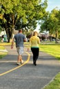 A couple walks on a city maintained green way trail.