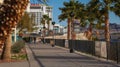 A couple walks at sunrise along Laughlin's Casino Riverwalk outdoor paved fitness walking path.