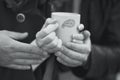 Couple warming his hands on a cup of hot tea Royalty Free Stock Photo