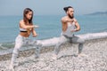 Couple warming out outdoors, doing squats together Royalty Free Stock Photo