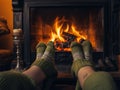 a couple warming their feet by the fireplace