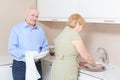 Couple washes dishes in the kitchen Royalty Free Stock Photo