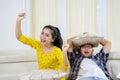 Couple watch basketball match with different emotions