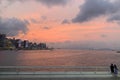 Couple watching evening glow in Victoria harbour in hong kong