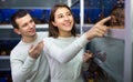 Couple watching fish in petshop. Royalty Free Stock Photo