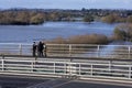 Couple watching flood waters from Carrington Bridge Royalty Free Stock Photo