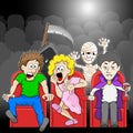 Couple is watching a horror movie movie in a cinema