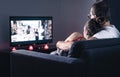 Couple watching movie or series. Online streaming and VOD service in tv screen. Film stream or television show. Cuddling. Royalty Free Stock Photo