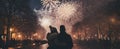 A couple watching New Year\'s Eve Fireworks in the city center. Firework explosion in the night sky. Happy new year Royalty Free Stock Photo