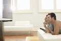 Couple Watching Plasma TV At Home Royalty Free Stock Photo